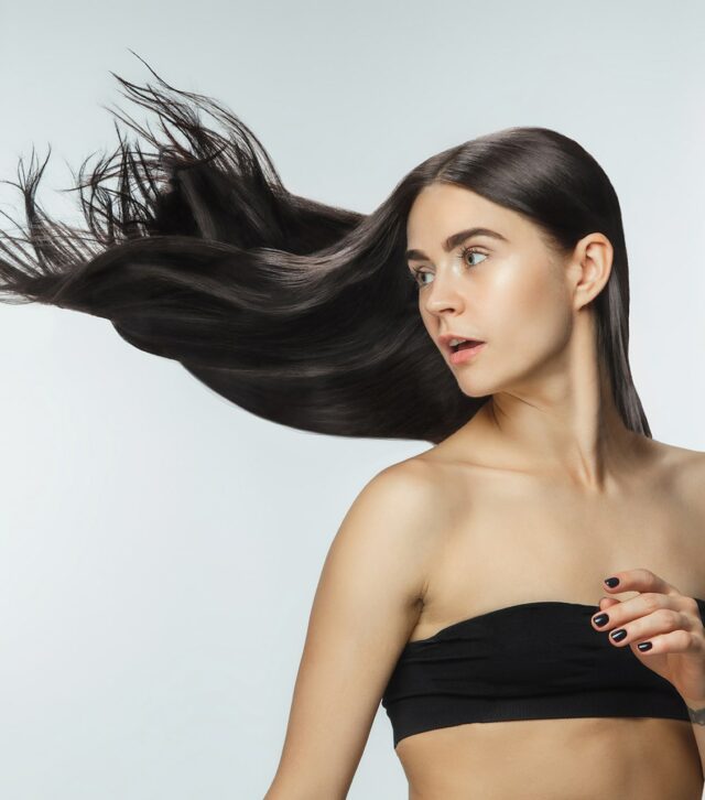 beautiful-model-with-long-smooth-flying-brunette-hair-isolated-white-studio-background